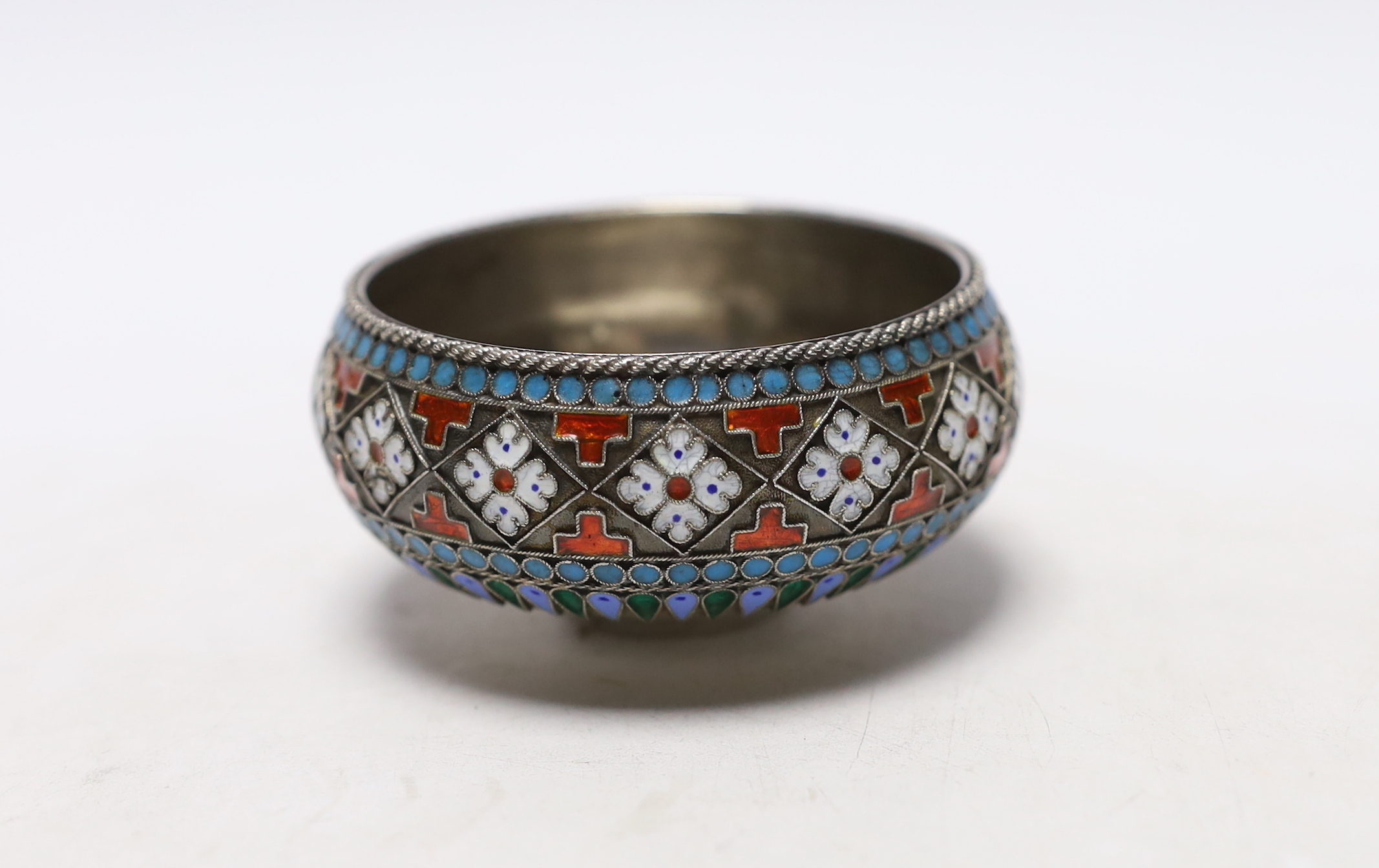 A late 19th century Russian 84 zolotnik and cloisonné enamel salt, assay master Lev Oleks, master Pavel Ovchinnikov, width 75mm, gross weight 58 grams.